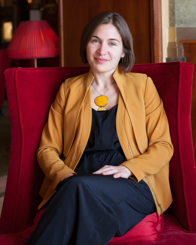 Maud Raber seated in a red chair